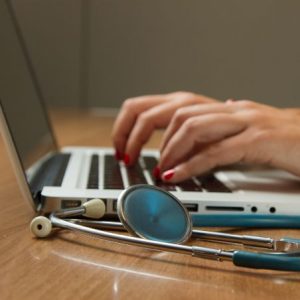 Hands typing on a laptop.